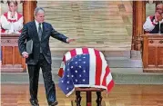  ?? [AP PHOTO/ANDREW HARNIK, POOL] ?? Former President George W. Bush touches the flag-draped casket of his father, former President George H.W. Bush, after speaking.