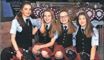  ??  ?? Delighted Katie Edmundson, Zoe Cook, Emma Hill and Claire Reid with the haul of trophies won by Oban High School Pipe Band.