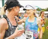  ?? Joel Page / Associated Press ?? Joan Benoit Samuelson (right) greets Deena Kastor at the Beach to Beacon 10K race.