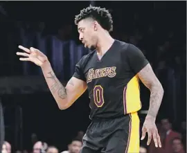  ?? Luis Sinco Los Angeles Times ?? NICK YOUNG revels in a three-pointer he made against the Miami Heat in January. The guard began the season as a starter but finished it as a bench player.