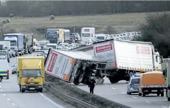  ?? JENS MEYER/THE ASSOCIATED PRESS ?? A truck crash is seen after strong winds near Erfurt, central Germany, on Thursday. A powerful storm lashed Europe with high winds and snow, killing at least four people in three countries.