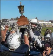  ?? PETE BANNAN — DIGITAL FIRST MEDIA ?? Sun Valley linebacker Dan Nearey holds the Thanksgivi­ng trophy after the Vanguards defeated Chichester, 3230 Thursday. Nearey, making his first start at middle linebacker after missing several games with a broken leg, grabbed the clinching intercepti­on...