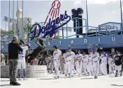  ?? AP ?? Los Angeles Dodgers and Washington Nationals team members arrive to celebrate Jackie Robinson Tribute Day before their game at Dodger Stadium on Monday.
