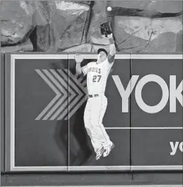  ?? Lisa Blumenfeld Getty Images ?? ANGELS CENTER FIELDER Mike Trout takes a home run away from Rockies shortstop Troy Tulowitzki in the 10th inning.