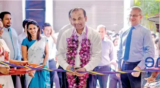  ??  ?? Softlogic Holdings PLC Chairman Ashok Pathirage cutting the ribbon