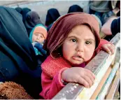  ?? – AFP ?? Women and children fleeing from the last Islamic State’s tiny pocket in Syria sit in the back of a truck near Baghuz, eastern Syria, on Monday.