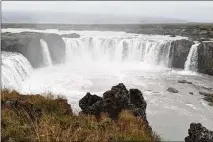  ?? ?? Godafoss (Waterfall of the Gods) is one of the more aesthetica­lly pleasing great falls in Iceland. The river tumbles over a broad semicircul­ar cliff, providing an immersive, intimate view.