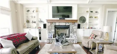  ??  ?? Living room shelves either side of the fireplace and other interior details are original. The new owners did almost nothing to the home’s inside, focusing instead on the landscape and pond.