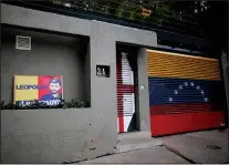  ?? AP PHOTO/ARIANA CUBILLOS ?? A banner with the image of opposition leader Leopoldo Lopez stands outside of his home in Caracas, Venezuela, Tuesday. Allies of two Venezuelan opposition leaders say Lopez and Antonio Ledezma have been taken by authoritie­s from the homes where they...