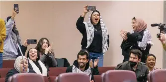  ?? ANTHONY VAZQUEZ/ SUN-TIMES PHOTOS ?? LEFT: Supporters of a resolution calling for a cease-fire in the Israel-Hamas war cheer at Monday’s meeting.