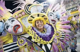  ?? WAGNER MEIER/GETTY ?? Members of Sao Clemente samba school perform during the Rio de Janeiro 2022 Carnival at Marques de Sapucai Sambodrome on Saturday in Brazil.