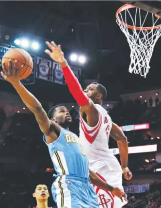  ?? Richard Carson, The Associated Press ?? Nuggets guard Aaron Brooks, a former Rocket, tries to score against Terrence Jones during Sunday’s game in Houston. Brooks nearly had a triple-double.