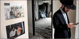  ?? PHOTO: GETTY IMAGES ?? A rabbi stands alongside photos of Rabbi Holtzberg at the re-opening