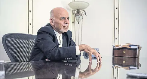  ??  ?? NOT A FAN: Afghan President Ashraf Ghani speaks on the phone with relatives of the Afghan soldier who was recently killed. He is no friend of ‘foreign mercenarie­s’ such as Erik D Prince — a man who is the talk of Kabul these days.