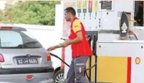  ?? — Reuters ?? A man pumps fuel into a car at a gas station in Tunis.