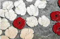  ??  ?? A production line of clay poppies before they are fired. The finished product can be worn, attached to a headstone or be presented as a gift.