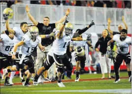  ??  ?? ABOVE: The Vandals are overcome with joy moments after their 33-30 upset of UNLV last September at Sam Boyd Stadium. LEFT:
Quarterbac­k Matt Linehan, scoring against the Rebels, returns for Idaho. He passed for 3,184 yards and 19 TDS last season.