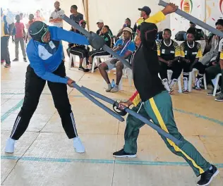  ??  ?? GIVING IT STICK: Eastern Cape's Asanda Swelindawo goes blow for blow with Limpopo's Dineo Monyepao during the 12th edition of the National Indigenous Games Festival in Polokwane