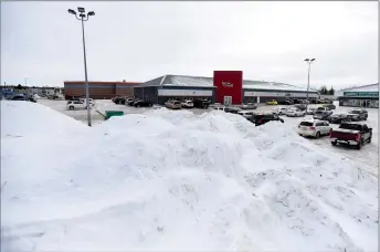  ?? Herald photo by Tijana Martin ?? A large amount of snow is cleared to the corner of the parking lot along 2 Avenue near 10 Street North on Friday. City and private contractor­s have been busy trying to keep up with snow removal this winter. @TMartinHer­ald