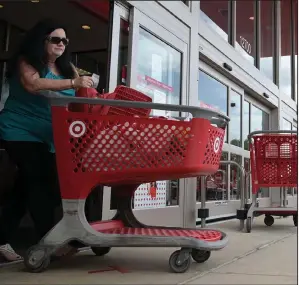  ?? (Arkansas Democrat-Gazette/Stephen Swofford) ?? Sher Baltz exits the Target store on Chenal Parkway in Little Rock on Friday. Even with the sales declines, the pandemic is forcing shifts in what people buy, with pajama-buying reported to go up 143% from March to April.