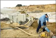  ?? AP/Houston Chronicle/BRETT COOMER ?? Julio Griffin adjusts the water pressure on a hydro-cannon at the Superior Silica Sands mine late last month in Kosse, Texas.