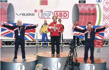  ??  ?? Roger Hamilton-Smith (right) receives his bronze medal for the Deadlift