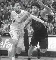  ?? AP/L.G. PATTERSON ?? (left) dribbles past Arkansas’ Anton Beard during the Tigers’ 77-67 victory Saturday. With the SEC Tournament in St. Louis, Missouri is playing two hours from its campus in Columbia and hopes to get a boost from fans at the Scottrade Center.