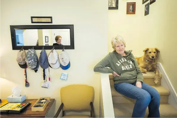  ?? ARLEN REDEKOP/PNG ?? Sheila Gutsche takes a break on steps in her Port Coquitlam home, with her daughter Shara visible in a mirror. Gutsche gave up her job to become Shara’s primary caregiver after Shara’s traumatic brain injury, suffered in an accident nearly 30 years ago.