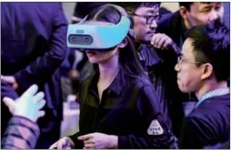  ?? PROVIDED TO CHINA DAILY ?? A visitor checks out a Vive Focus at a developer conference held in Beijing. Users can enjoy the device without attaching it to personal computers or smart phones.
