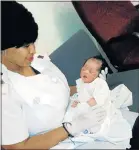  ??  ?? SAFE AND SOUND: Dora Nginza Hospital staff nurse Shaeemah Stoltz holds the baby rescued in Lorraine, Port Elizabeth, yesterday