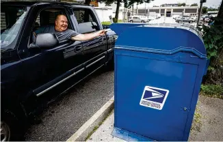  ?? JIM NOELKER / STAFF ?? A local resident uses a mailbox at the post office on East Fifth Street in Dayton on Wednesday. The mailbox was one of several in the Dayton area from which items were reported stolen.