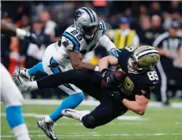  ?? Associated Press ?? New Orleans Saints tight end Josh Hill (89) pulls in a pass reception over Carolina Panthers strong safety Mike Adams (29) in the first half of an NFL football game Sunday in New Orleans.