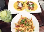  ??  ?? A refreshing mojito accompanie­s chicken tacos
and ancho fries at the Camacho Garage preview Wednesday. The regular menu will feature curly fries after a
soft opening this weekend.