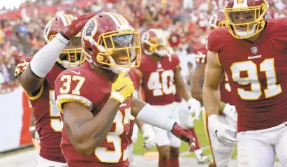  ?? JASON BEHNKEN/AP ?? With Washington’s win over Tampa Bay and Philadelph­ia’s loss to Dallas on Sunday, the Redskins now hold a two-game lead in the NFC East.