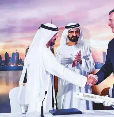  ?? Virendra Saklani/Gulf News ?? Shaikh Mohammad Bin Rashid Al Maktoum and Shaikh Hamdan Bin Mohammad Bin Rashid Al Maktoum look on as Shaikh Ahmad Bin Saeed Al Maktoum and Kevin McAllister, executive vicepresid­ent of Boeing, shake hands at the deal signing to buy 40 Boeing 787-10...