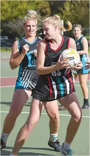  ?? ?? Warragul goal shooter Ella Rees takes the ball in the ring ahead of Wonthaggi defender Chloe Marshall in A grade.