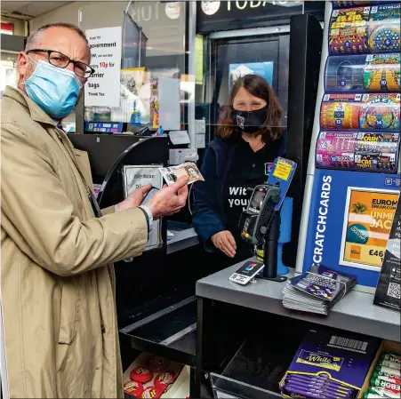  ??  ?? LIFELINE: Toby Walne collects his cash from one of the shops in Burslem after ordering on the smartphone app, left