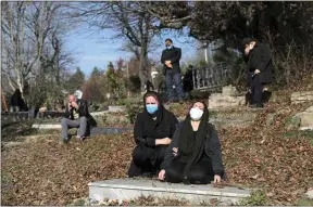  ?? EBRAHIM NOROOZI / AP ?? In this Dec. 17, 2020, file photo, mourners attend the funeral of a woman who died from COVID-19 at a cemetery in the outskirts of the city of Ghaemshahr, in northern Iran.