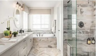  ??  ?? The unique tile treatment in the ensuite adds a rich textural element, while the glass encased shower is spacious.