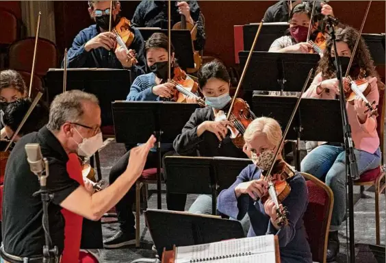  ?? Photos by Lori Van Buren / Times Union ?? Conductor David Alan Miller, left, leads rehearsal with the Albany Symphony Orchestra at the Troy Savings Bank Music Hall in Troy.