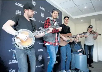 ?? JASON BAIN/EXAMINER ?? Canadian country singer/songwriter Dan Davidson (plaid) performs along with his backing band during a meet and greet in the Hart Room on Tuesday at the Days Inn and Suites in Lindsay. Davidson opened for Brett Kissel's We Were That Song Tour at the...
