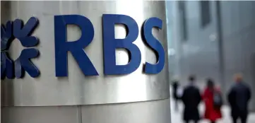  ??  ?? People walk past a Royal Bank of Scotland office in London, Britain. — Reuters photo