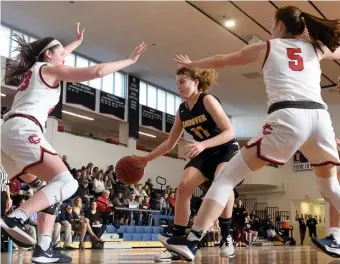  ?? JIM MICHAUD / BOSTON HERALD FILE ?? PLAYOFF PICTURE: Andover’s Amelia Hascom, center, is blocked by Central’s Emily Downer, left, and Claire Finney during their game on Jan. 5.