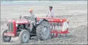  ?? HT FILE ?? A farmer uses tractor-operated till-drill machine to sow paddy seeds using the DSR method.