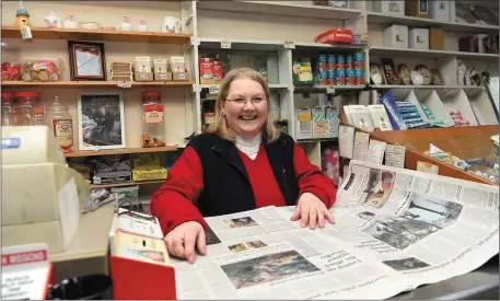  ?? Photo by Michelle Cooper Galvin ?? Olive Donovan of Donovan’s, Kenmare, taking up a typical pose of her Dad’s, reading the daily paper on the shop counter. Donovan’s is closing shortly.