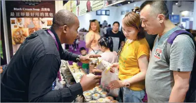  ?? XINHUA ?? A foreign merchant introduces products to visitors at the 11th Central China Investment and Trade Expo in Nanchang, capital of Jiangxi province, on May 18.