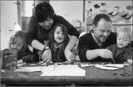  ??  ?? Staff help children with their artwork at Hatching Dragons, the UK’s first Chinese-English nursery school.