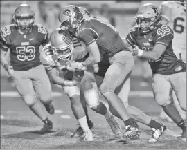  ?? Dan Watson/The Signal (See additional photos on signalscv.com) ?? Santa Barbara High quarterbac­k Jeremiah Nicholson (10) is sacked in the third quarter by Saugus defender Daniel Gilmartin (17), Luc Borrelli (unseen) and Jaelin Kinney (46) at College of the Canyons on Friday.