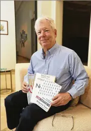  ?? CONTRIBUTE­D BY ANNE RYAN / UNIVERSITY OF CHICAGO ?? Richard Thaler of the University of Chicago poses with his books Monday at his home after winning the 2017 Nobel prize in economics. Thaler found that people often make decisions that run counter to their best interests.