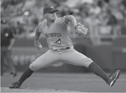  ?? AP PHOTO ?? Making his major league debut, Toronto Blue Jays pitcher Sean Reid-Foley winds up during a game at Kauffman Stadium in Kansas City, Mo., on Monday.Royals: